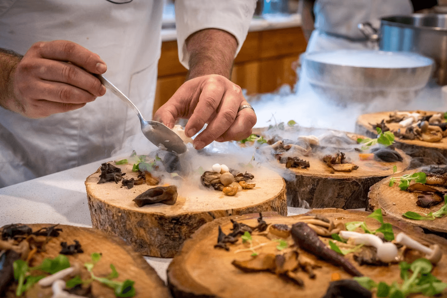 Chef plating a smoky seasonal tasting menu